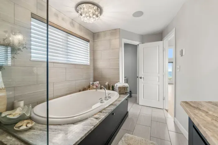 Luxurious bathroom with soaking tub, dual vanity and stunning tiled shower. Clean towels provided for all guests.