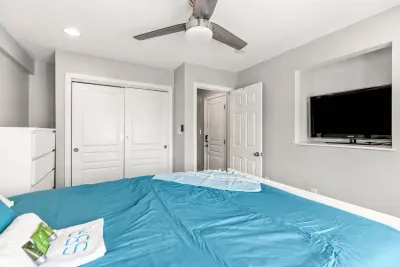 Nautical unit Queen bedroom with a smart TV and clean provided linens.