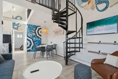Living room with comfy couch, smart TV, and access to the private balcony