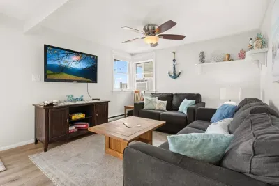 Living room, located right off the kitchen, standard couches (not sleeper sofas)