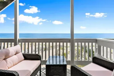 Private deck with outdoor seating, perfect for a morning coffee or afternoon drink (patio furniture not available Nov-Mar). Beach access right from this deck!