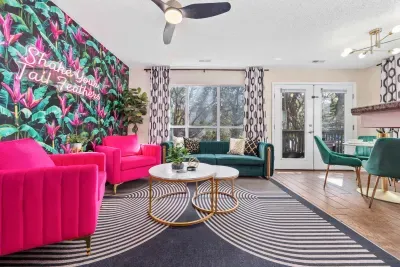 Open kitchen, living room and dining area with smart TV and doors leading to private patio