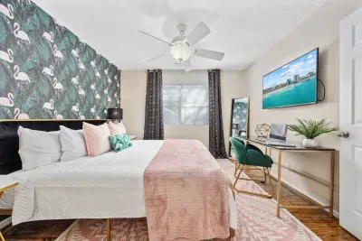 Primary bedroom with king bed, work-from-home desk, smart Roku TV, walk in closet and ensuite bathroom with shower tub.