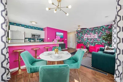 Open kitchen, living room and dining area with smart TV and doors leading to private patio