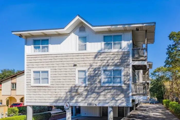 Front, street view, of the IBIS Condominiums, just a half block to the beach with covered garage parking.