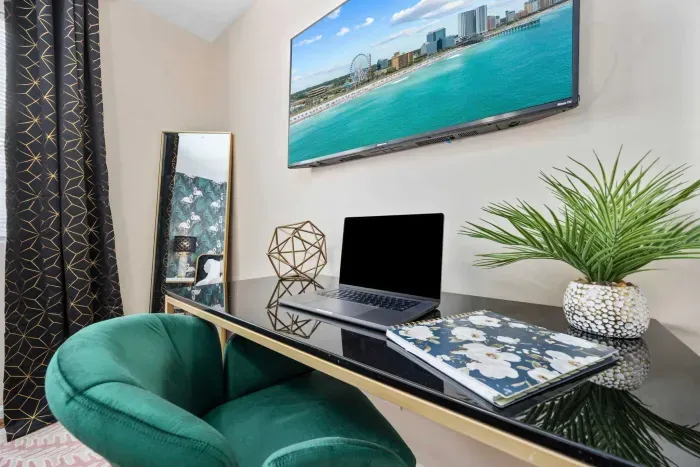 Primary bedroom with king bed, work-from-home desk, smart Roku TV, walk in closet and ensuite bathroom with shower tub.