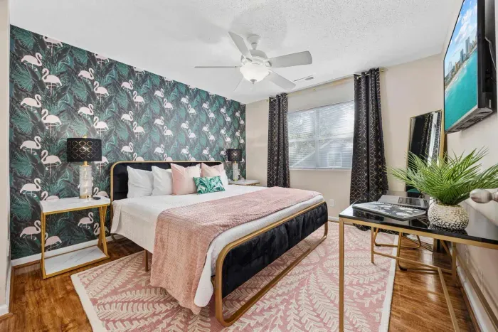 Primary bedroom with king bed, work-from-home desk, smart Roku TV, walk in closet and ensuite bathroom with shower tub.