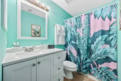 Ensuite bathroom off the primary bedroom with king bed.