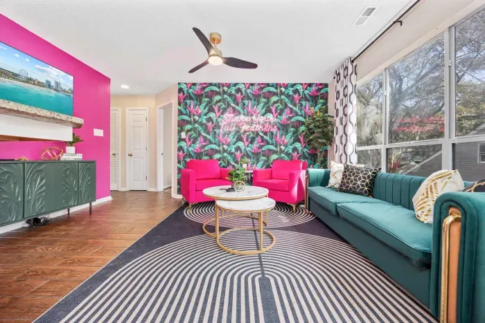 Open kitchen, living room and dining area with smart TV and doors leading to private patio