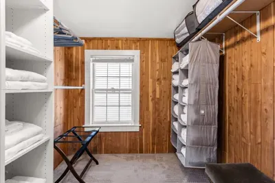 Main bedroom with king bed, vaulted ceilings, flatscreen smart Roku TV, walk in closet and work-from-home desk.