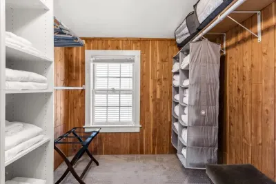 Main bedroom with king bed, vaulted ceilings, flatscreen smart Roku TV, walk in closet and work-from-home desk.
