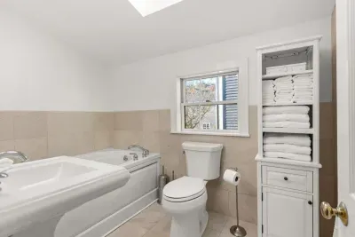 Full bathroom located on the second floor, with tub and walk-in tiled shower. Clean towels and linens provided for all guests