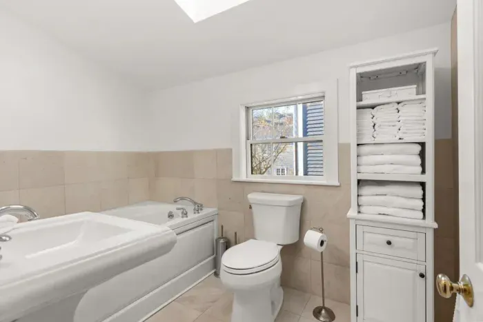 Full bathroom located on the second floor, with tub and walk-in tiled shower. Clean towels and linens provided for all guests