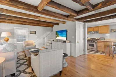 Open living room (with sleeper sofa), kitchen and dining area. Flat screen smart Roku TV, central heat/AC, strong WiFi throughout, the woodstove is inoperable and not to be used.