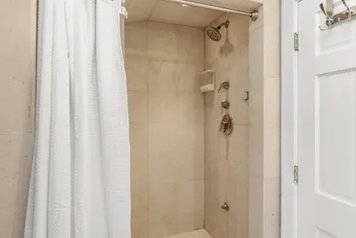 Full bathroom located on the second floor, with tub and walk-in tiled shower. Clean towels and linens provided for all guests