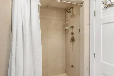 Full bathroom located on the second floor, with tub and walk-in tiled shower. Clean towels and linens provided for all guests