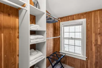 Main bedroom with king bed, vaulted ceilings, flatscreen smart Roku TV, walk in closet and work-from-home desk.
