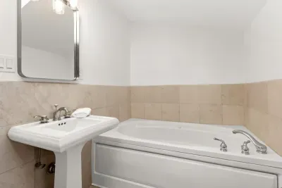 Full bathroom located on the second floor, with tub and walk-in tiled shower. Clean towels and linens provided for all guests