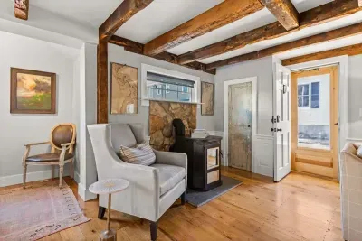 Open living room (with sleeper sofa), kitchen and dining area. Flat screen smart Roku TV, central heat/AC, strong WiFi throughout, the woodstove is inoperable and not to be used.