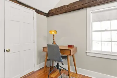 Main bedroom with king bed, vaulted ceilings, flatscreen smart Roku TV, walk in closet and work-from-home desk.