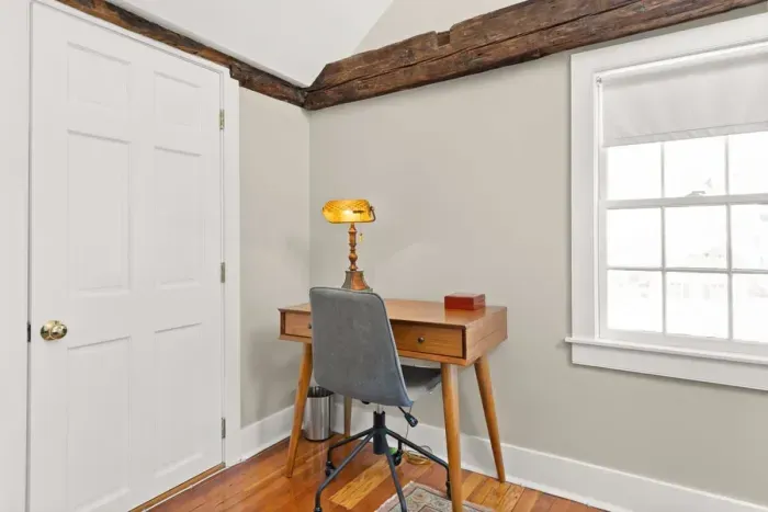 Main bedroom with king bed, vaulted ceilings, flatscreen smart Roku TV, walk in closet and work-from-home desk.