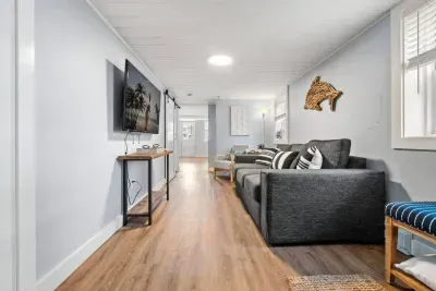 Bottom unit: Living room with couch (not a sleeper sofa) and smart Roku TV to enjoy your streaming services and basic cable.