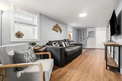 Bottom unit: Living room with couch (not a sleeper sofa) and smart Roku TV to enjoy your streaming services and basic cable.