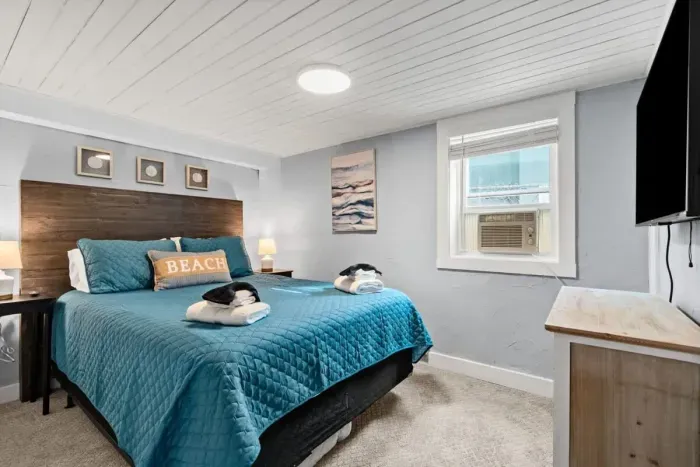 Bottom unit: Bedroom #1 with queen bed, and mounted flatscreen smart Roku TV