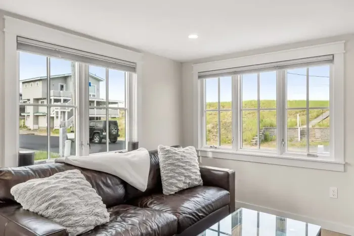 Fully equipped open kitchen and living room with large island, high-end appliances, kitchen table, washer/dryer, smart tv