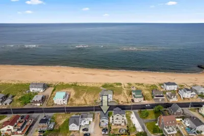 Aerial view, across the street from the beach, large private deck, walking to all the bars & restaurants including the Sunset Club, Riptide Cafe, and The Cottage Creamery!