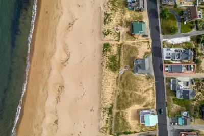 Aerial view, across the street from the beach, large private deck, walking to all the bars & restaurants including the Sunset Club, Riptide Cafe, and The Cottage Creamery!