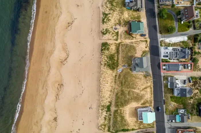 Aerial view, across the street from the beach, large private deck, walking to all the bars & restaurants including the Sunset Club, Riptide Cafe, and The Cottage Creamery!
