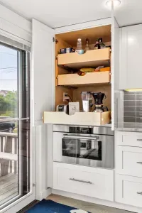 Fully equipped open kitchen and living room with large island, high-end appliances, kitchen table, washer/dryer, smart tv