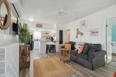Open, bright and quiet living space with wall mounted Roku TV and pull-out couch.