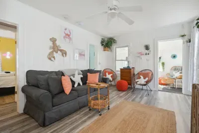 Open, bright and quiet living space with wall mounted Roku TV and pull-out couch.