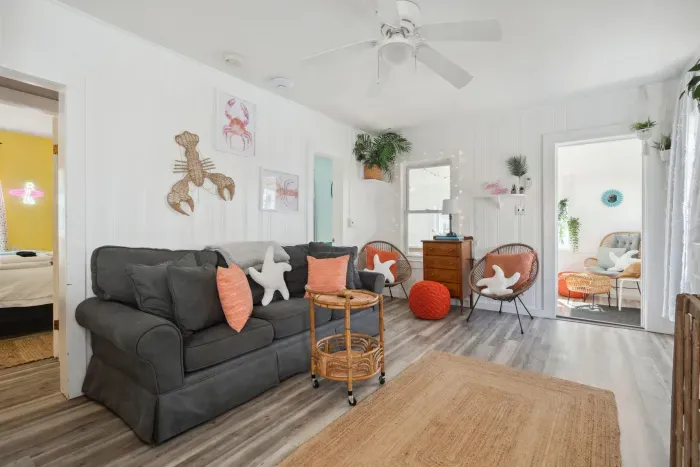 Open, bright and quiet living space with wall mounted Roku TV and pull-out couch.