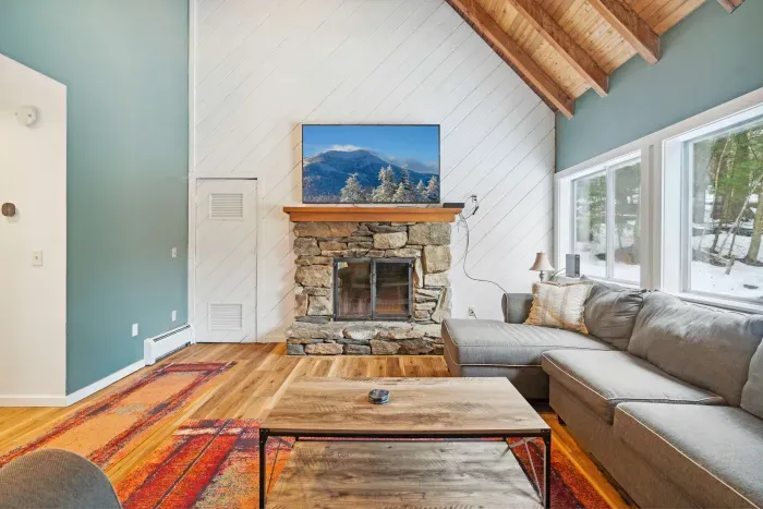 The living room! Equipped with a Samsung Smart TV and comfy sectional. Please note fireplace is inoperable