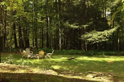 The firepit and the woods in the backyard. The old growth behind the home is stunning in the fall! The fire pit is unavailable during the winter months