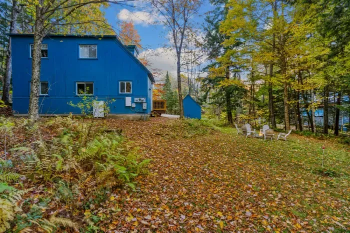 A backyard view of the home and the yard