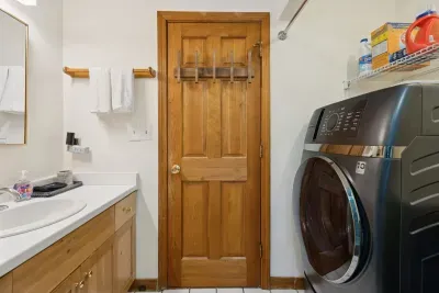 The full bathroom located off the hallway with clean towels provided for all guests. Brand new all in one laundry machine in this bathroom! It also has a brand new standing shower!