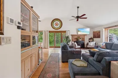 The living area with plenty of seating for everyone, a Queen pullout sofa, and a smart tv!