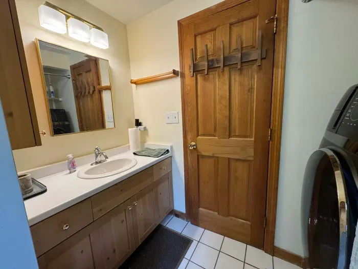 The full bathroom located off the hallway with clean towels provided for all guests. Brand new all in one laundry machine in this bathroom! It also has a brand new standing shower!