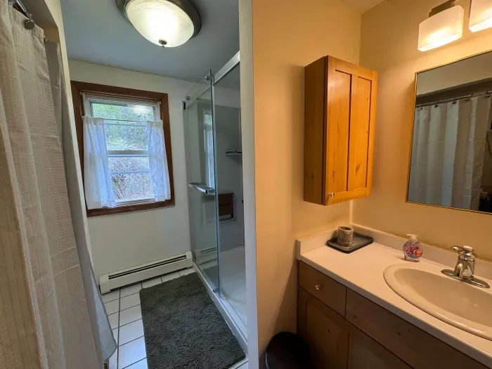 The full bathroom located off the hallway with clean towels provided for all guests. It has a brand new standing shower! Brand new all in one laundry machine in this bathroom!
