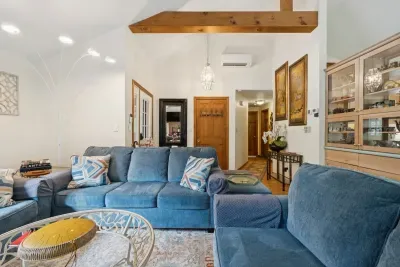 The living area with plenty of seating for everyone, a Queen pullout sofa, and a smart tv!