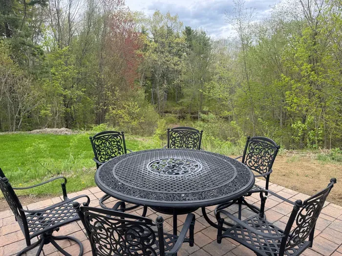 The outdoor patio off of the kitchen with views of the Lamprey River!