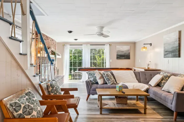 Living room with shuffleboard, Smart TV with the ability to login to streaming platforms, and access to the backyard!