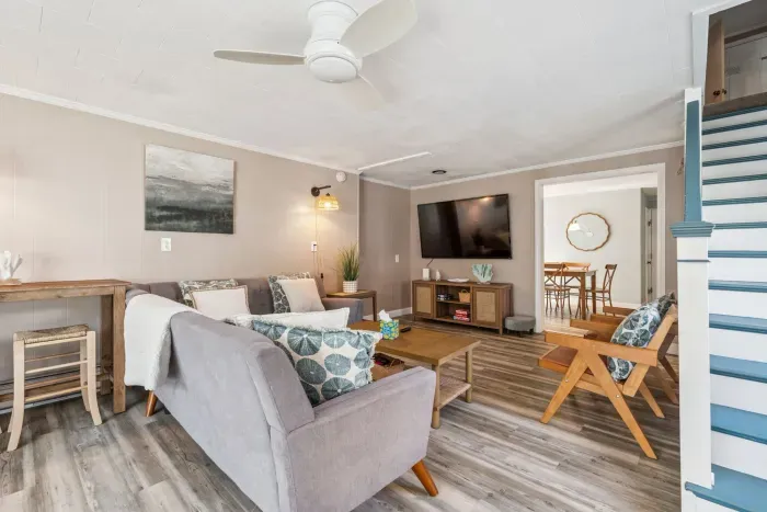 Living room with shuffleboard, Smart TV with the ability to login to streaming platforms, and access to the backyard!