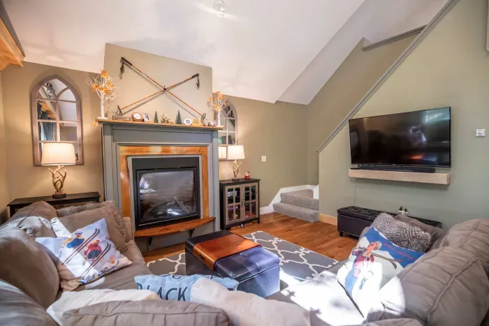 Large living room featuring a comfy couch, Smart TV, and gas fireplace