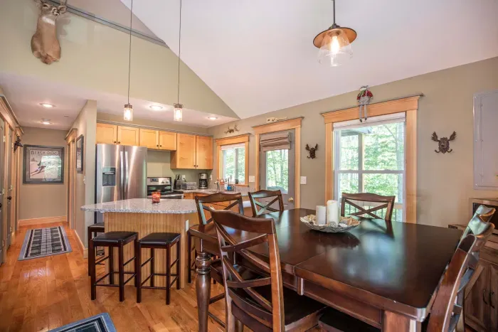 Dining table with seating for 6, and an additional 4 barstools at the kitchen island