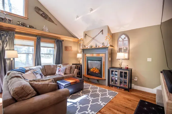 Large living room featuring a comfy couch, Smart TV, and gas fireplace